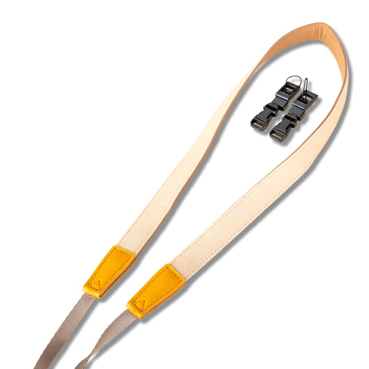 Camera strap with yellow end pieces on a white background